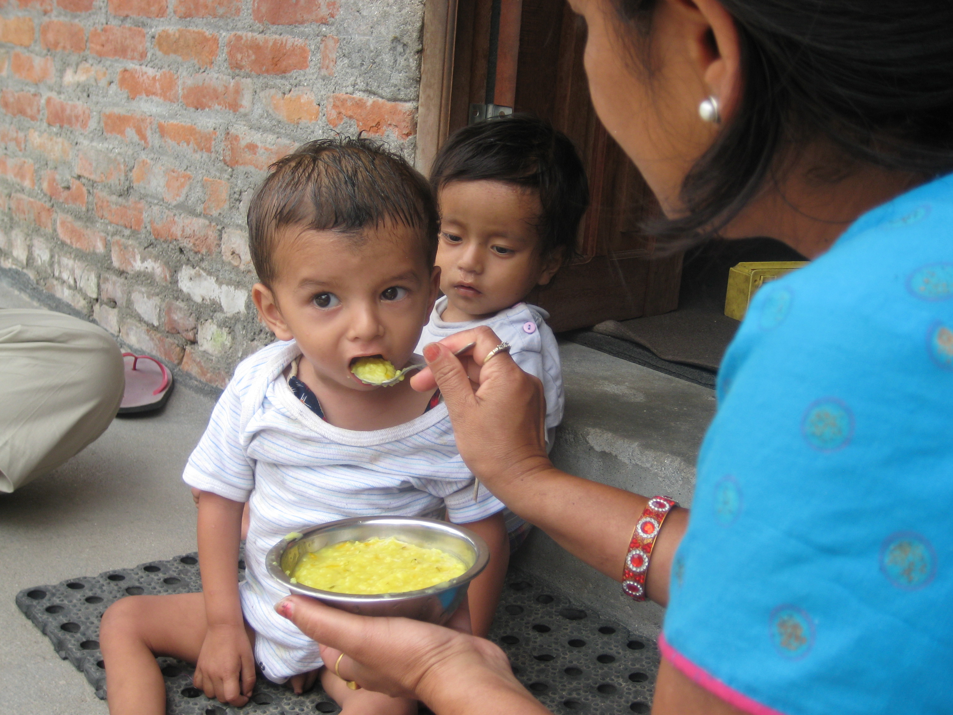 Nepal Teachers Rachel and Britanny Feeding Baby